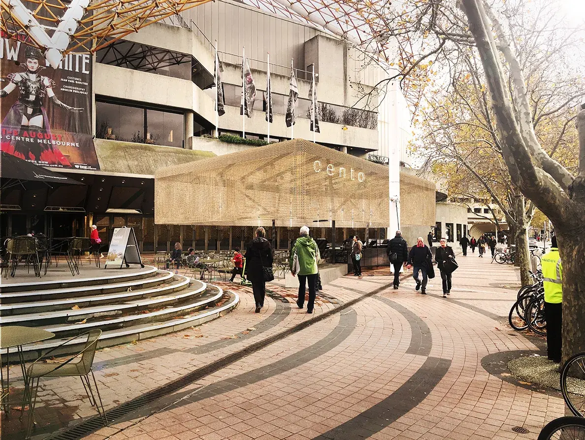 A wide shot of the "Cento" cafe (the predecessor to "Protagonist") at the Arts Centre Melbourne, showing its signature golden mesh canopy.
