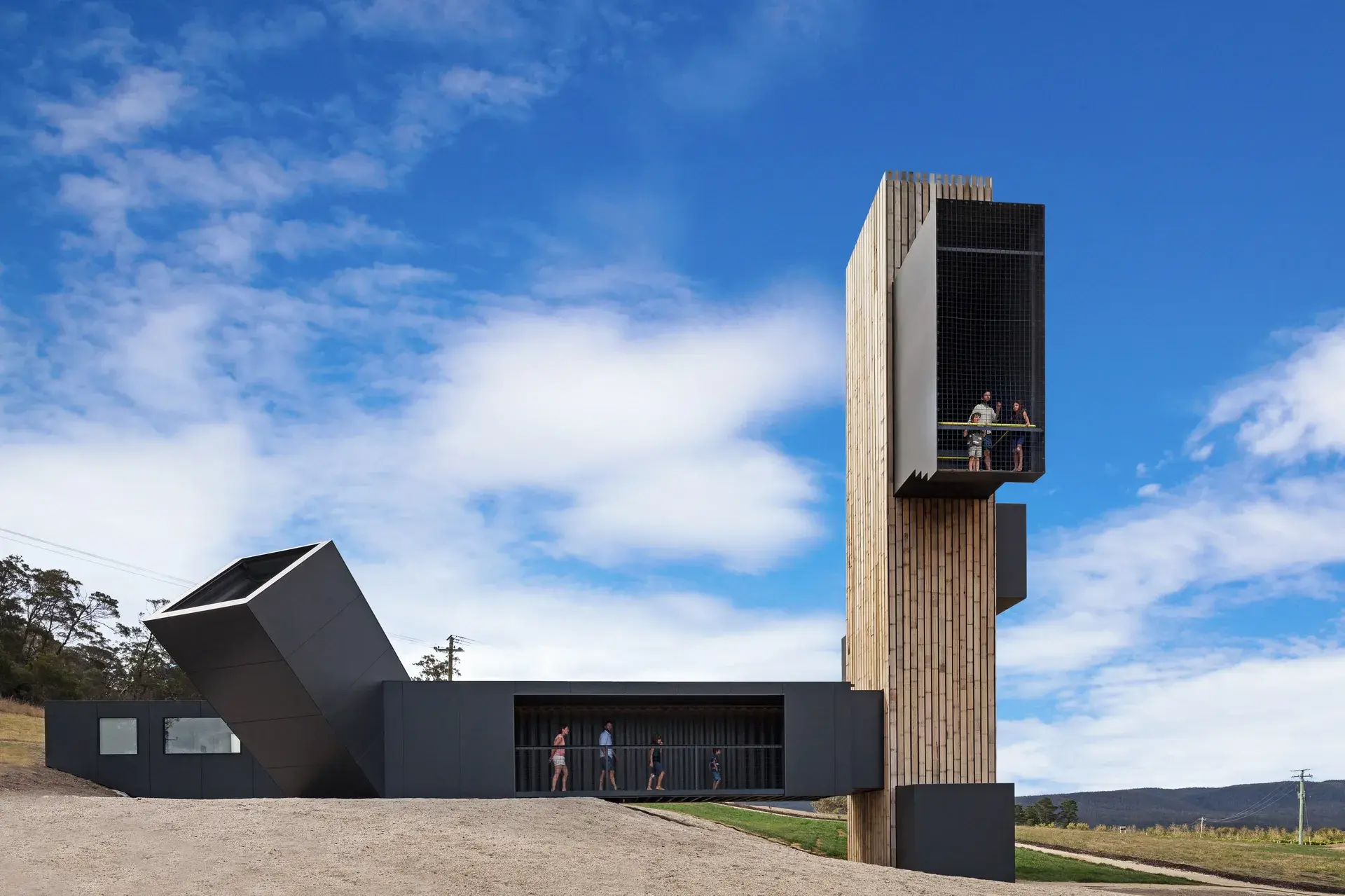 The Devil’s Corner Lookout and Cellar Door in Apslawn, Tasmania, featuring a striking black tower and cantilevered viewing boxes made from repurposed shipping containers.