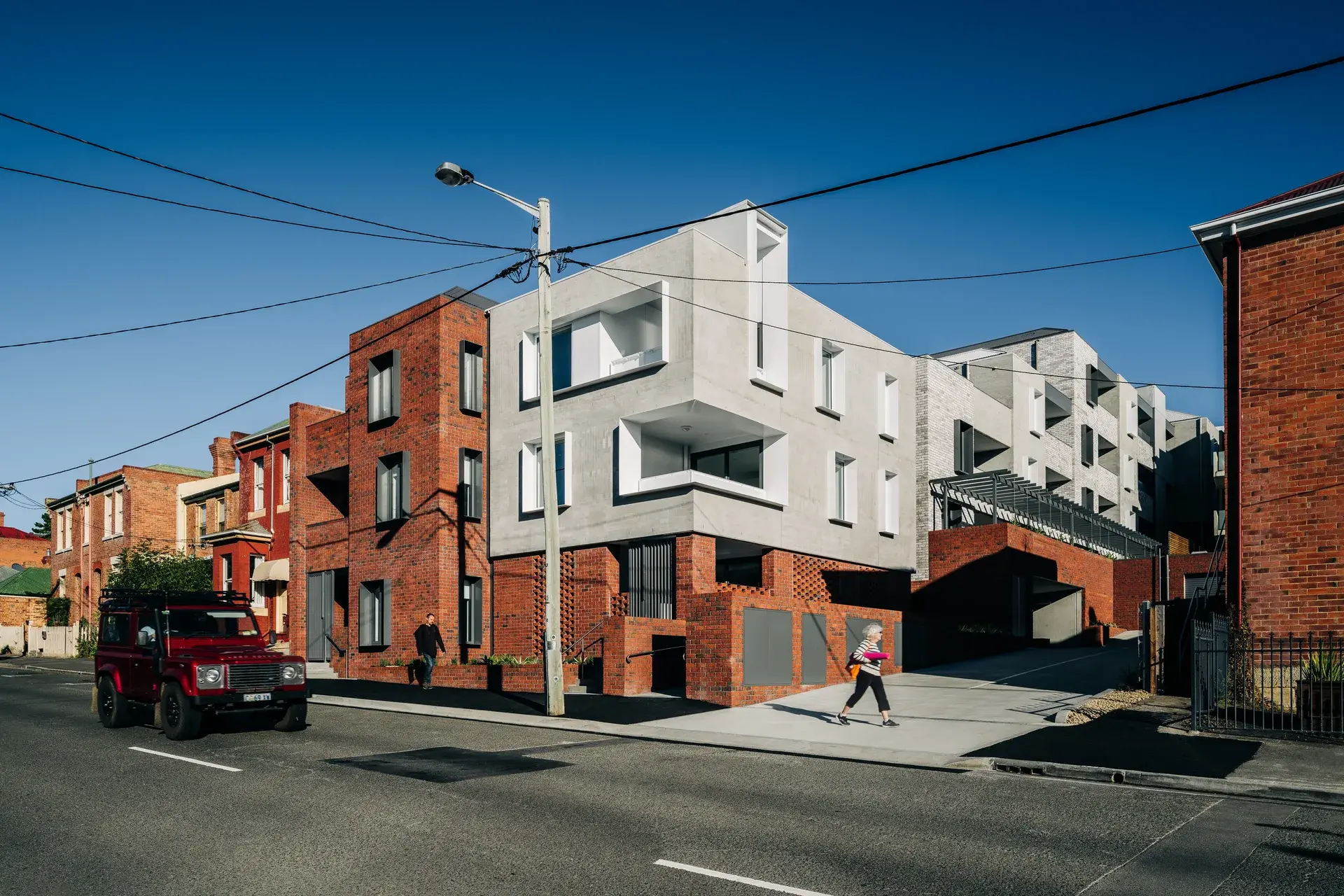 Goulburn Street apartments located on a street front featuring  dark red brick and light-coloured bricks.