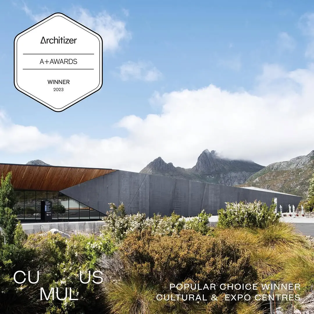 An external image of Dove Lake Viewing Shelter with Cradle Mountain peaks in the background, overlayed with the Architizer A+ Awards Winner branding for the Popular Choice Winner and Cultural & Expo Centre category.