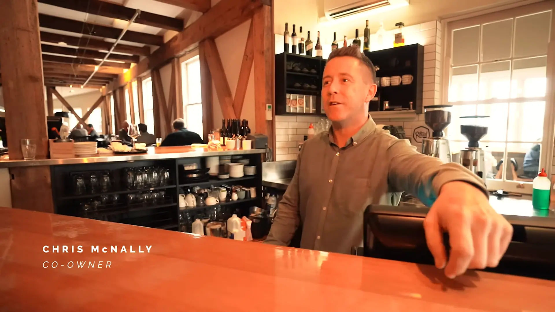 Chris McNally, co-owner of Stillwater, behind the bar in the restaurant’s warm timber interior.