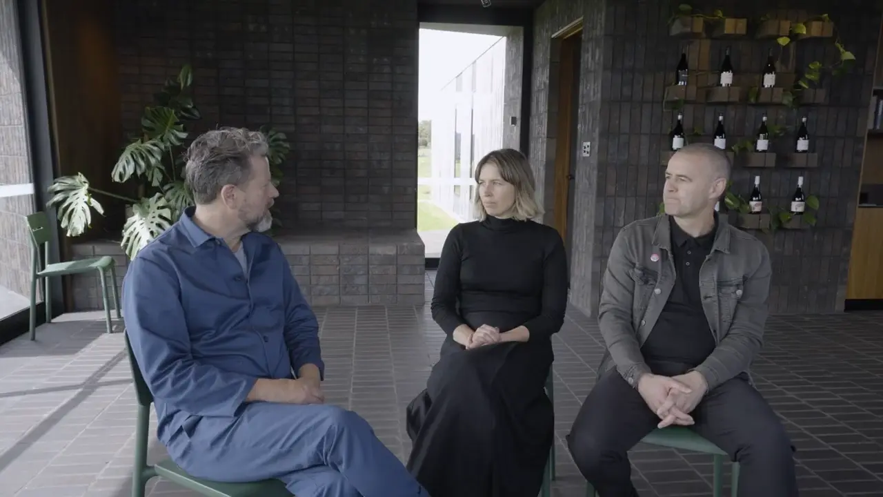 An image of Todd Henderson being interviewed with a fellow colleague.