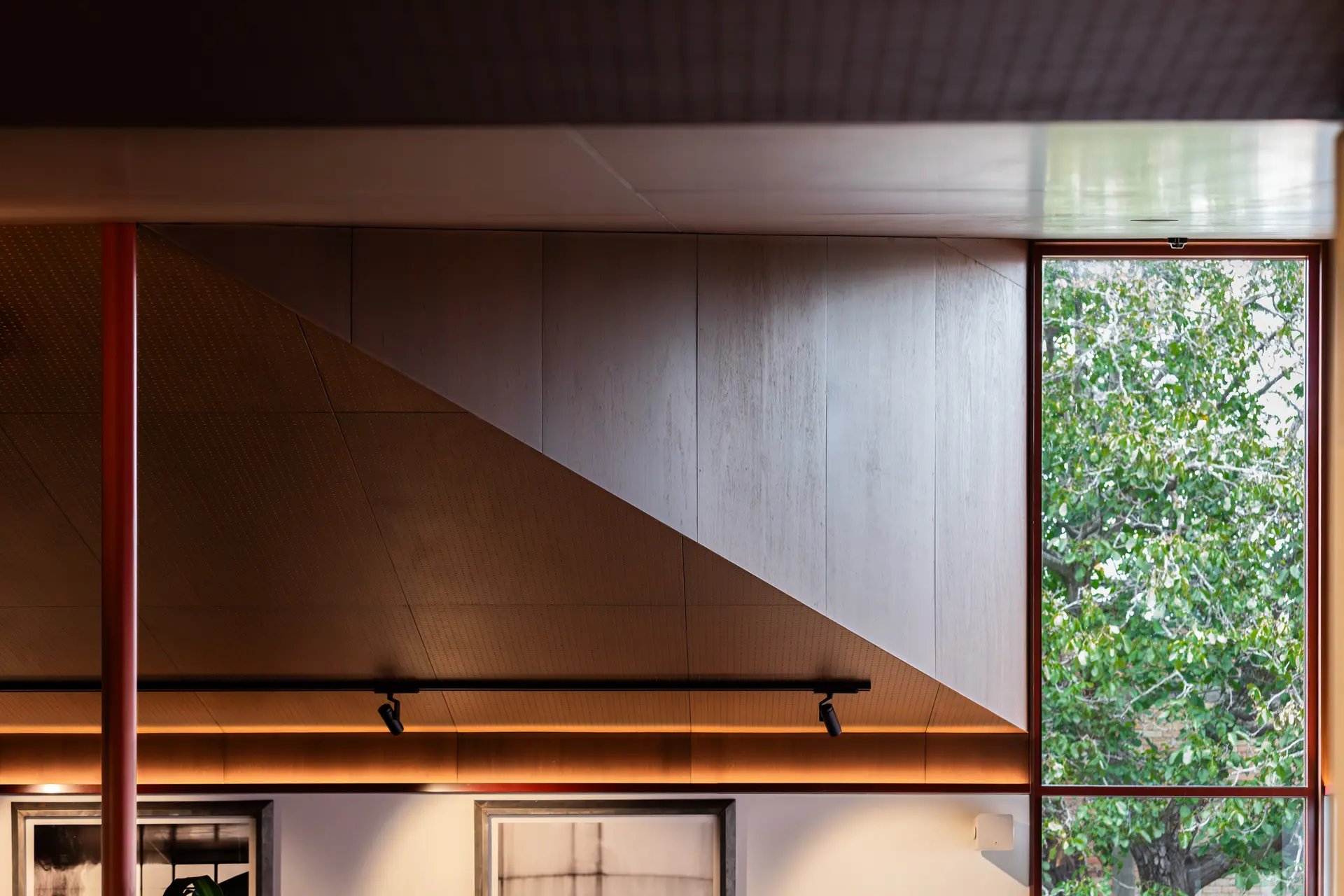 Detail of the leafy view out of the tall feature window.