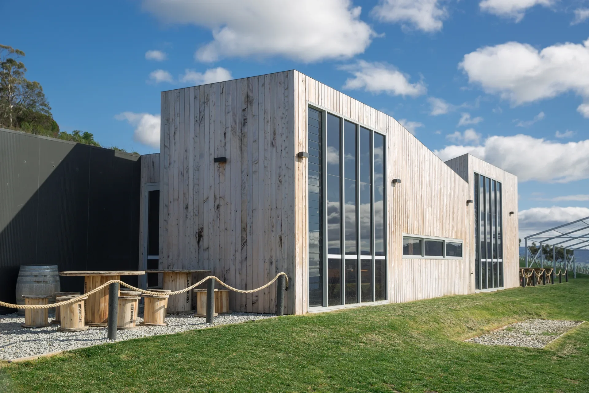 The front facade is a series of timber and metal clad box-like forms, with full height feature windows that face the Coal Valley.