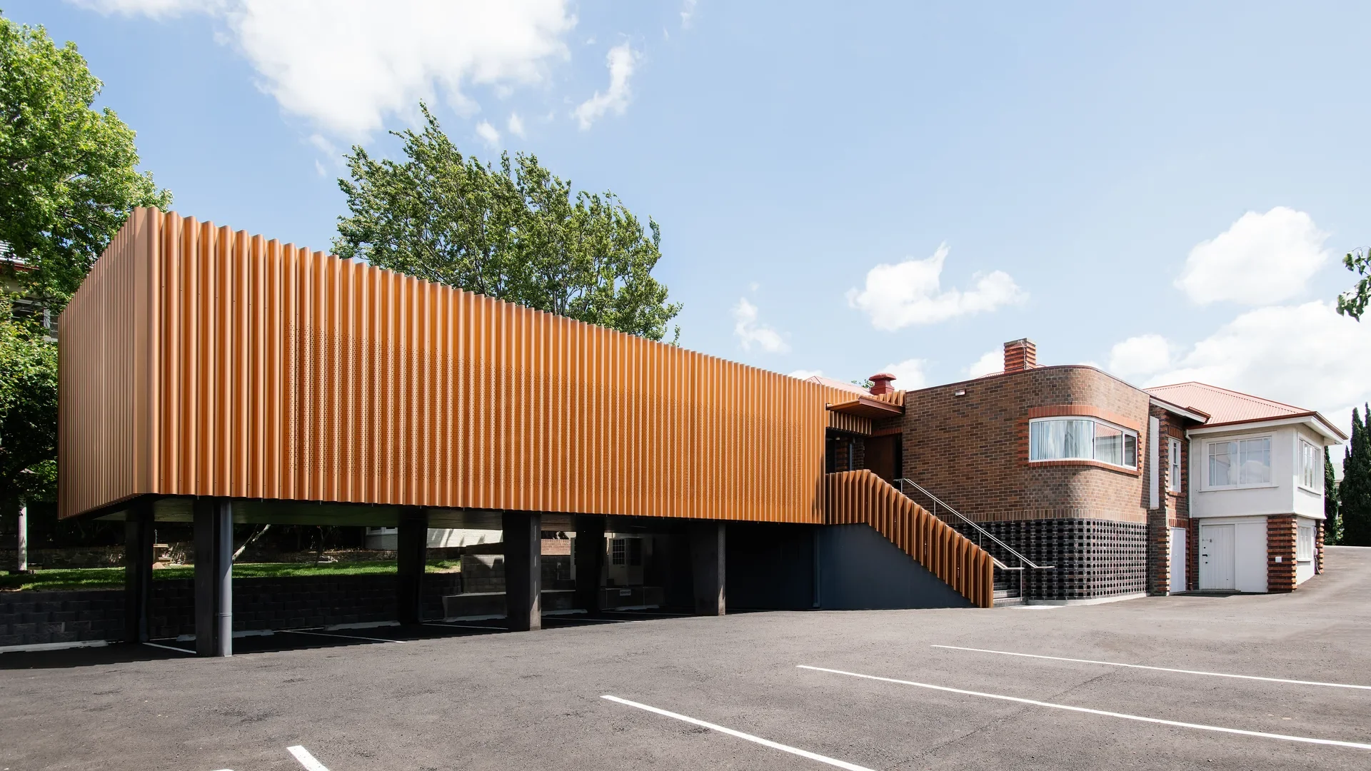 The extension is clad in copper toned aluminum screening.