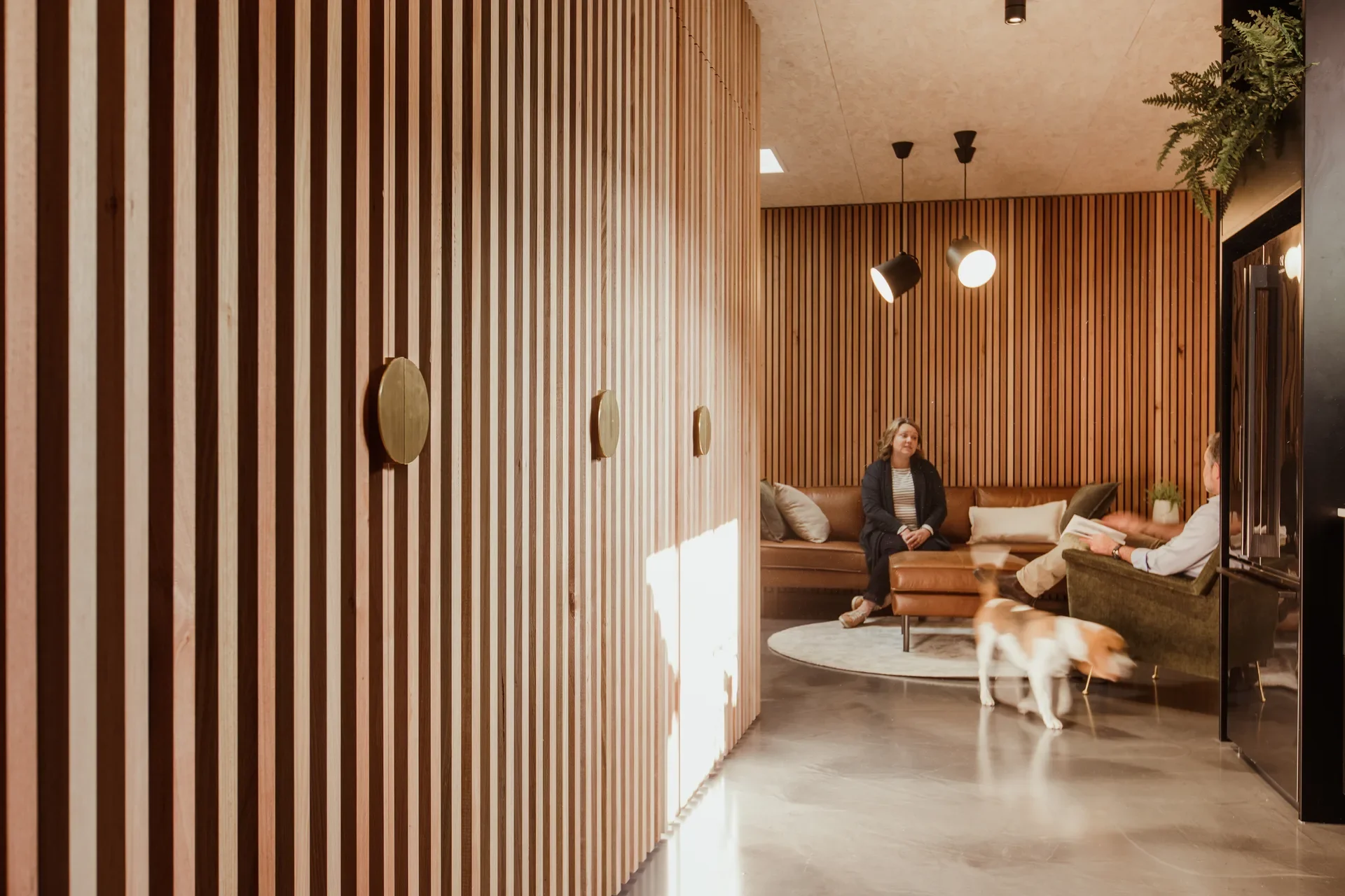 The vertical Tas oak battens line each side of the corridor, leading through into the informal meeting space.