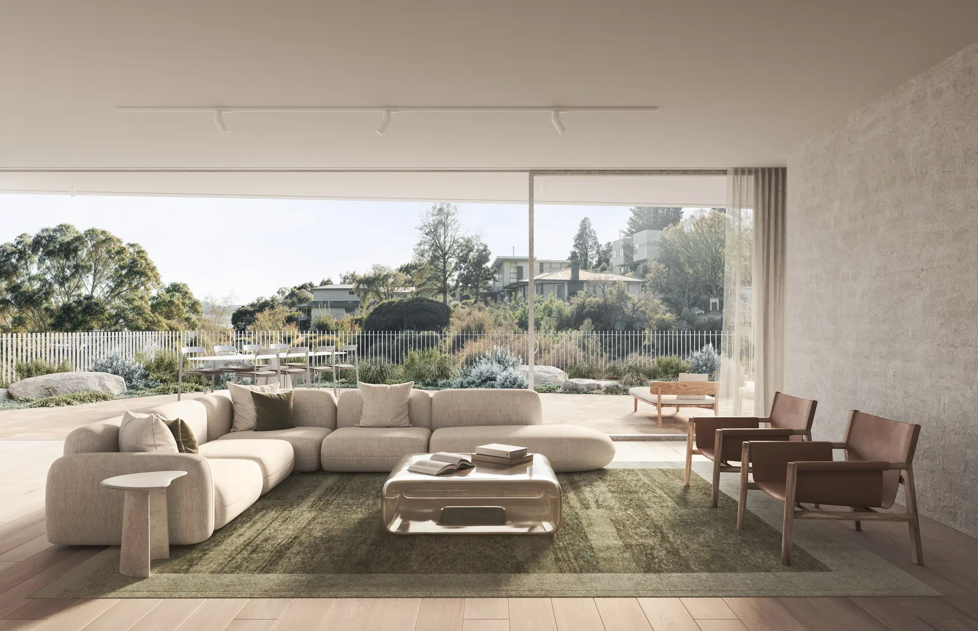 An interior render of an open-plan living space with a low, upholstered modular sofa, timber-framed armchairs and a soft textured rug set on wide timber flooring. Full-height sliding glazing opens to a terrace, with sheer curtains, stone walls and muted finishes creating a calm, neutral palette that extends into the landscape.