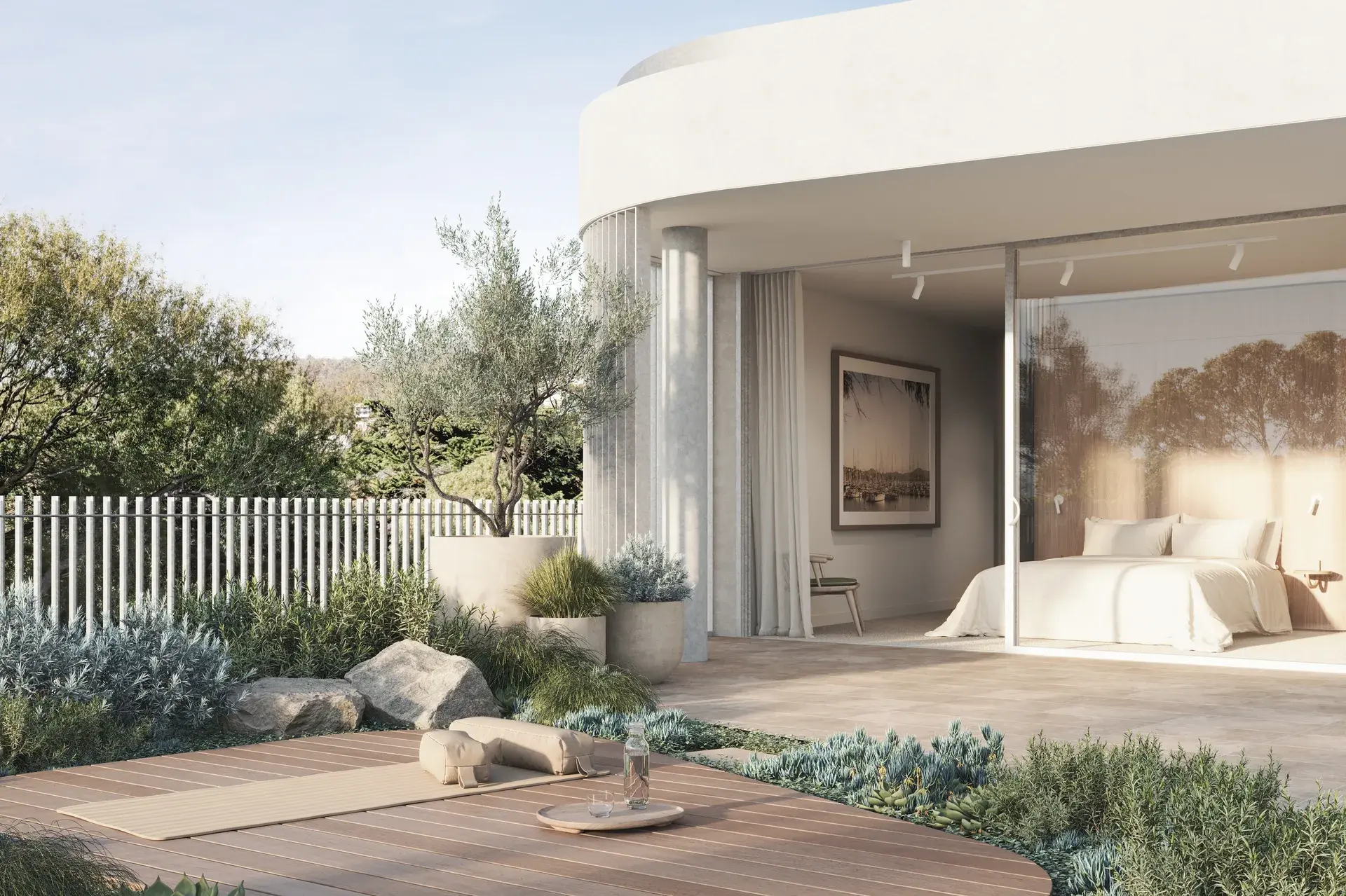 An exterior render of a penthouse room, where sliding glass doors open from a bedroom onto a landscaped garden with low planting, stone edging and a timber deck platform. The curved concrete edge and integrated planters continue the building’s soft, cohesive material language.