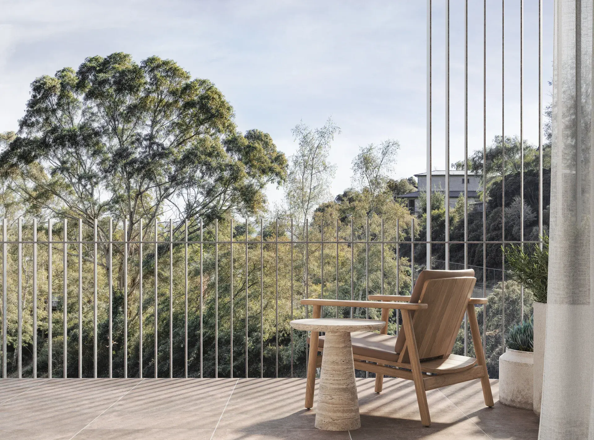 A terrace render with a timber outdoor lounge chair and sculptural stone side table set on a tiled surface, enclosed by fine vertical balustrades. The space overlooks dense tree canopy, with soft shadows cast through the screen onto the floor.