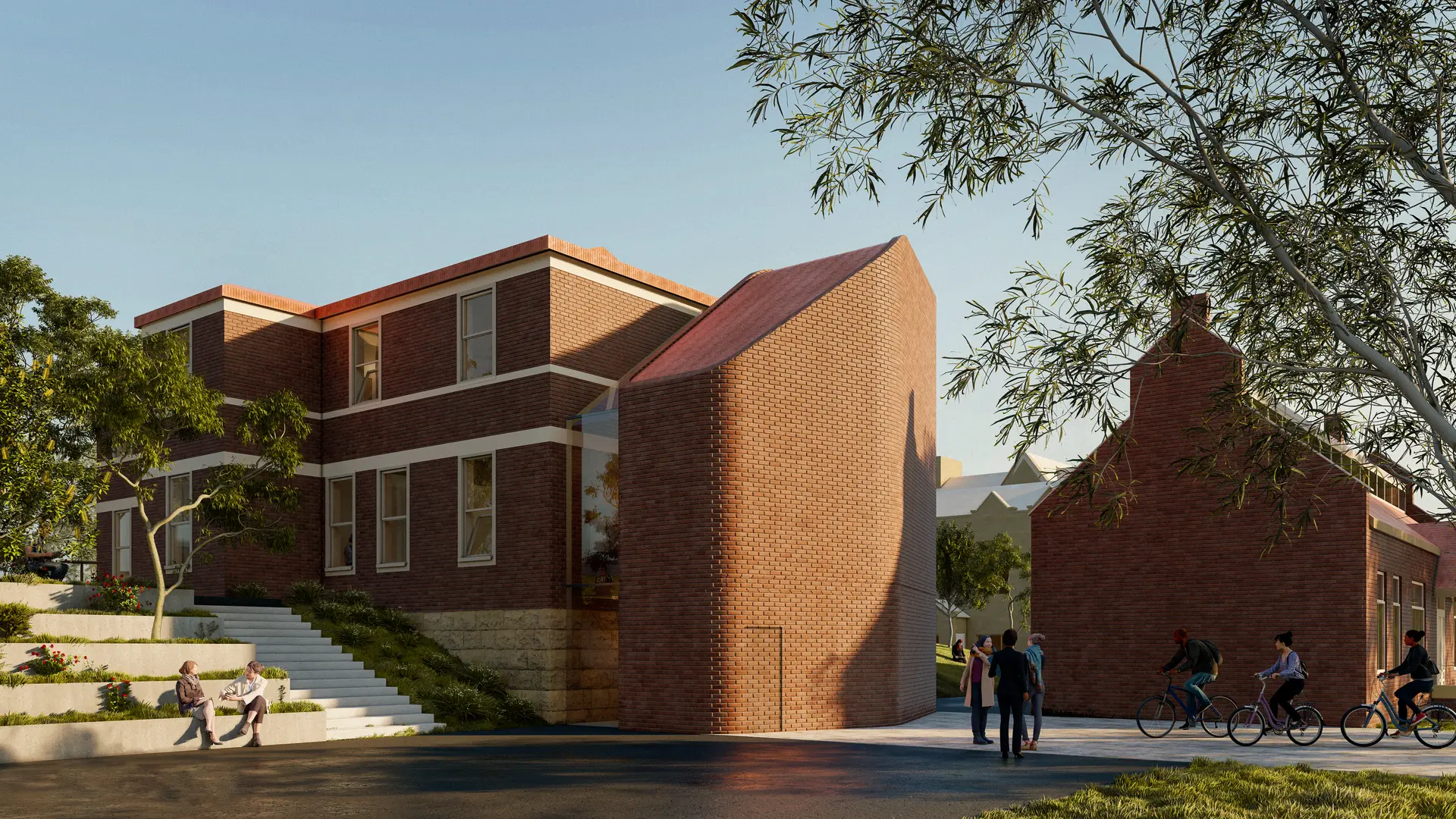 A rendered rear perspective of the UTAS Graphics and LARC precinct, showing a composition of restored and new brick forms with articulated rooflines and softened corners. A new connecting volume sits between buildings, reinforcing circulation links and shared entry points, while the campus edge is activated by students gathering, moving and occupying the stepped terrain.