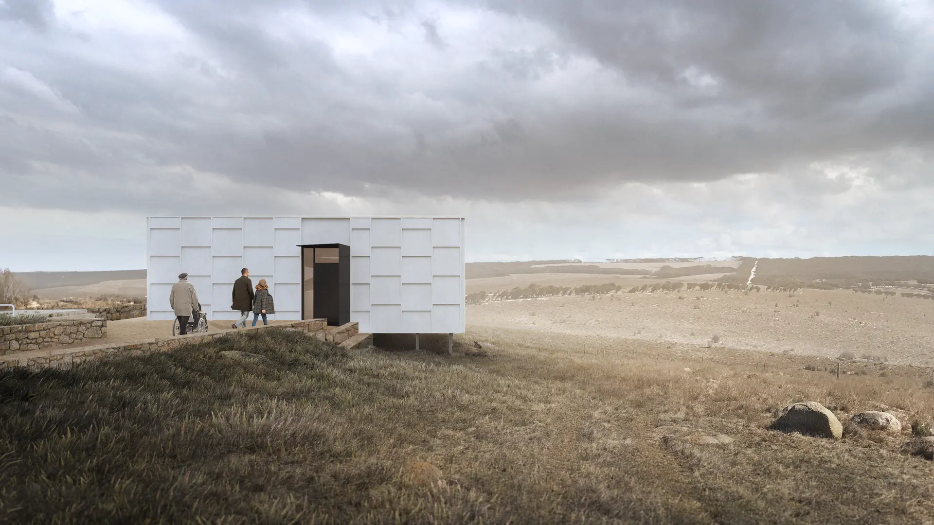 The side entry view of the pavilion shows a more enclosed facade of textured, light-toned panels, punctuated only by a central dark door with a glimpse of the space illuminated within. Visitors approach along a low stone path, with the building positioned against an open, rugged, dry grassy landscape under heavy, atmospheric, and dramatic skies.