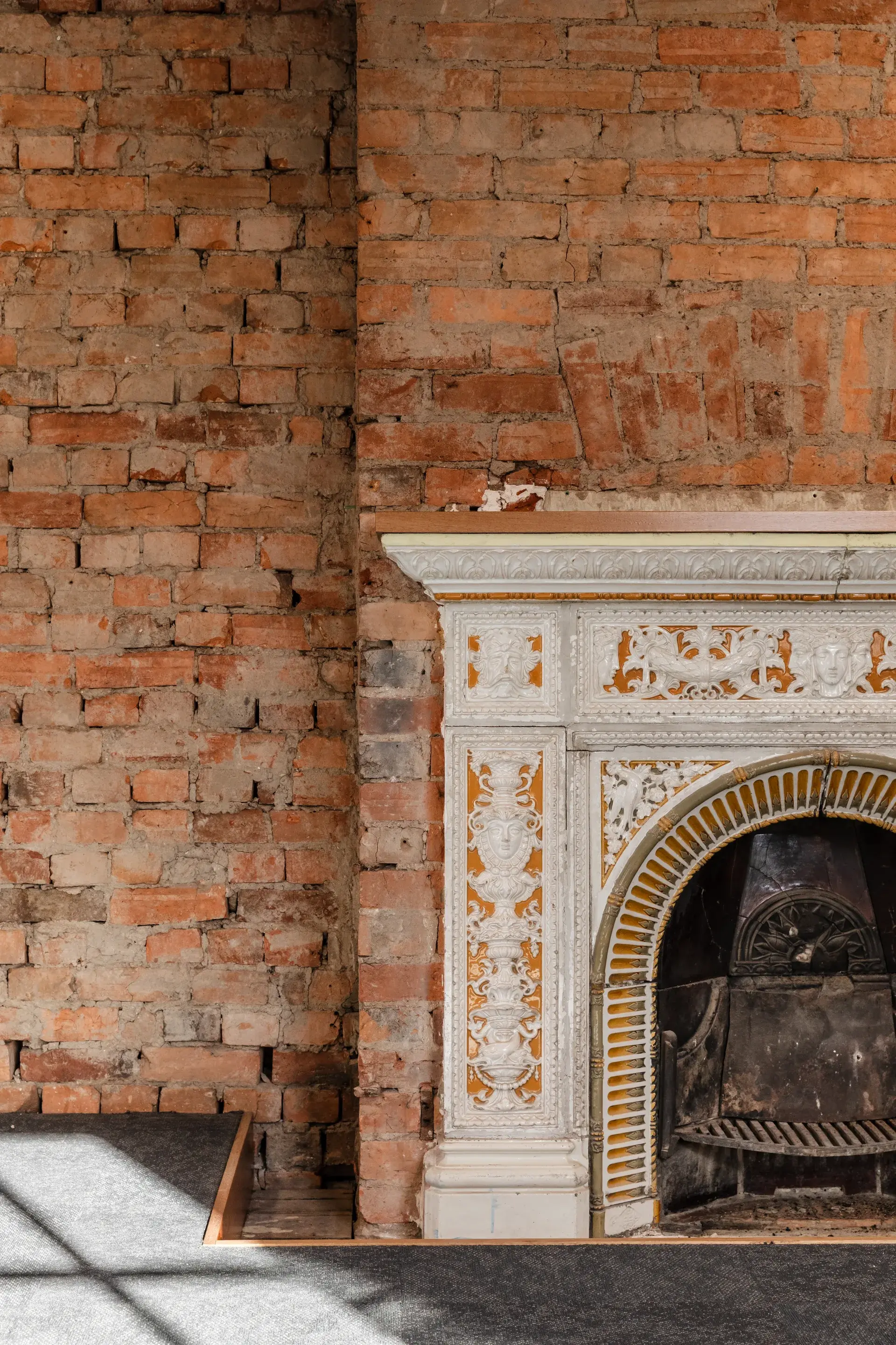 A detail of the exposed heritage brickwork and fireplace.