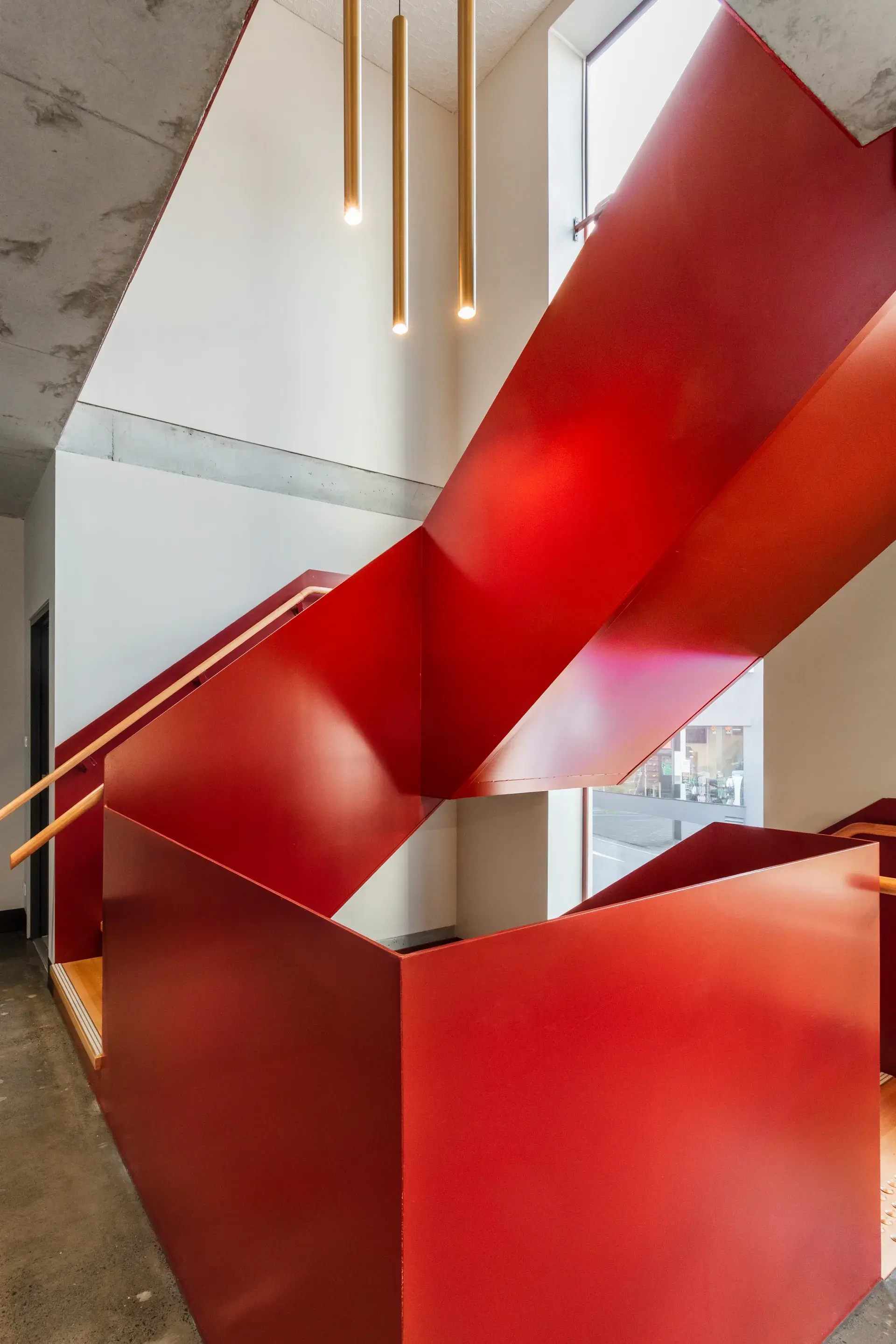 A view of the new stair case, wrapped in red steel.