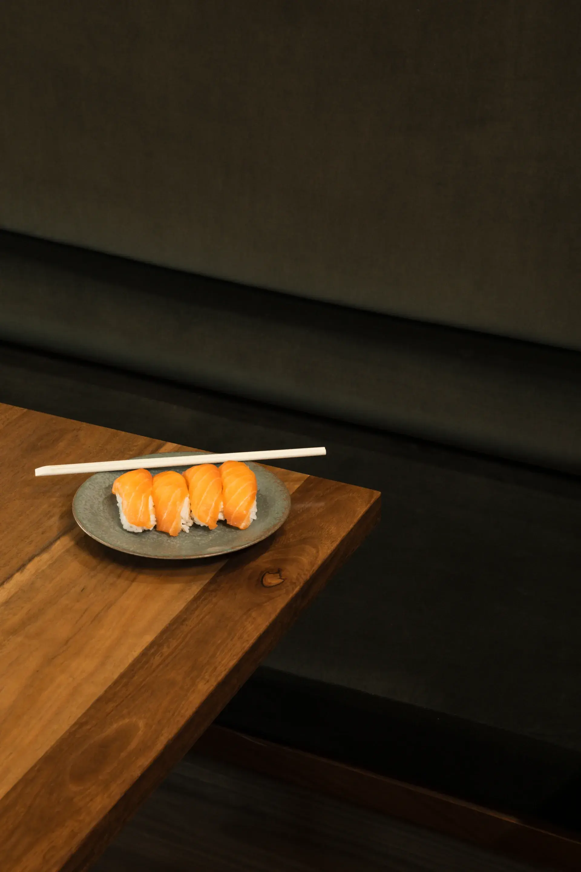 Cleo Velvet bench seating paired with deep spotted gum timber panelling and tables, creating a warm and sophisticated atmosphere throughout.