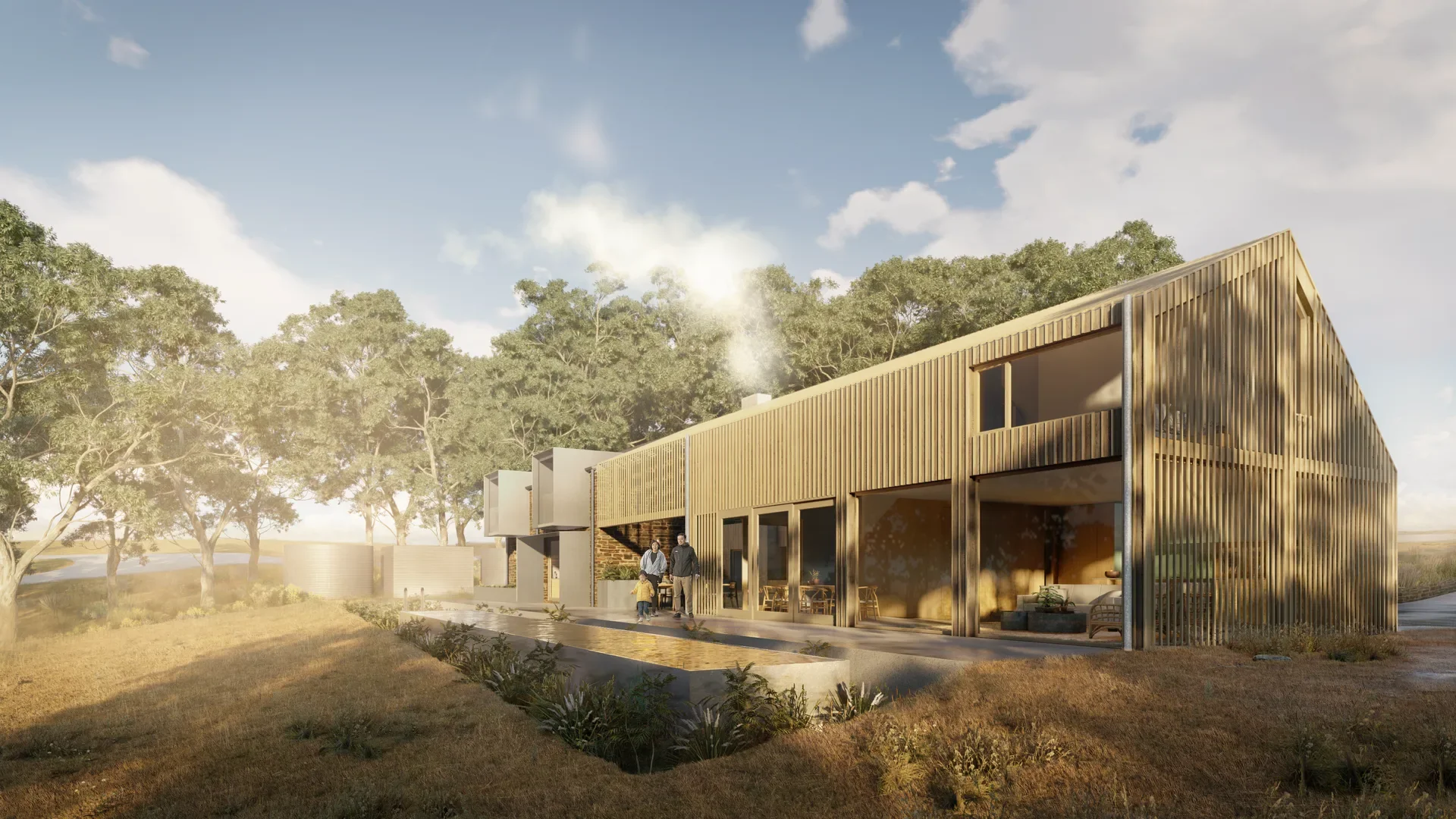A timber-slat longhouse with a gabled roof. A family stands on the patio near a reflecting pool, with smoke rising from the chimney against a backdrop of lush eucalyptus trees.