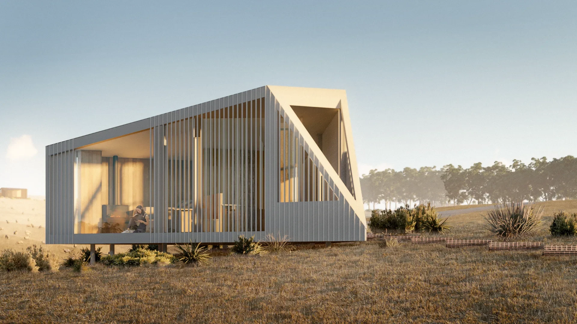 A monolithic cabin with light-coloured vertical cladding and a sharp, asymmetric silhouette. Elevated on pylons over a grassy field, the design features slatted glass walls that reveal a person relaxing by a fireplace inside a minimalist interior.