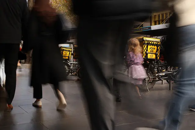 City street scene with pedestrians in motion, capturing urban life and movement